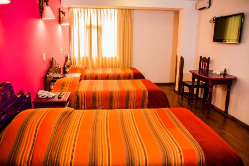 Un pat sau paturi într-o cameră la Hotel Warari
