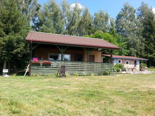 a small house with a large yard in front of it at Pod Sową in Drawsko Pomorskie