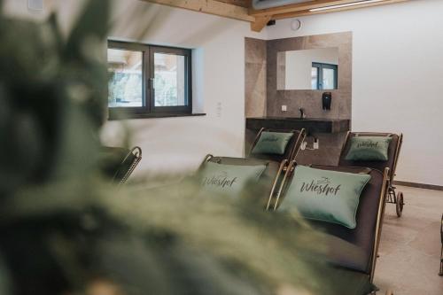 a row of chairs in a room with a mirror at Appartements Wieshof in Sankt Johann im Pongau