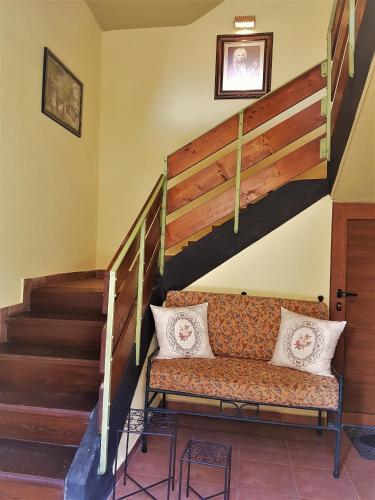 a couch in a room with a staircase at Casa Vivaldi in Velingrad