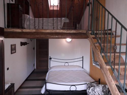 a bedroom with a bunk bed and a staircase at Agriturismo Il Balcone sulla Valle in Bedero Valcuvia