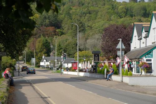 a street in a small town with a car on the road at Morlea Bed & Breakfast in Drumnadrochit