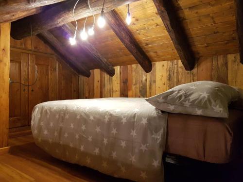 a bedroom with a bed in a log cabin at Aosta con Vista - appartamento in centro in Aosta