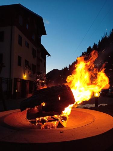 a fire in the middle of a street at night at Orobie Alps Resort in Roncobello