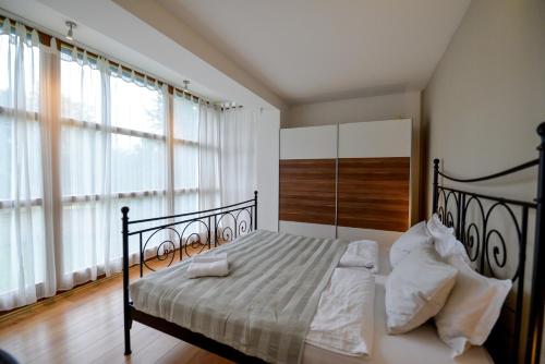 a bedroom with a bed with white sheets and pillows at Eva's house in Ivanec