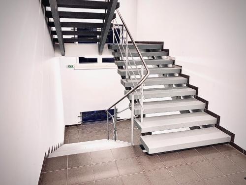 a staircase in a building with a white wall at Jazz Time Studio in Birštonas