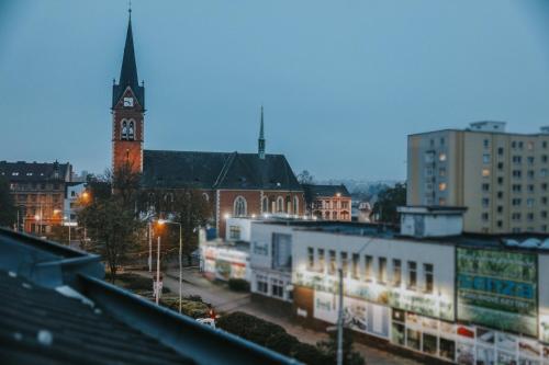 a city with a clock tower and a church at OASIS Teplice in Teplice