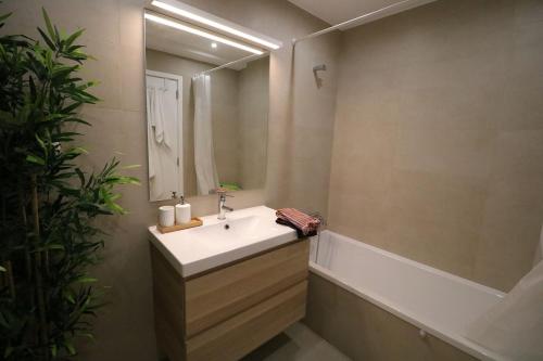 a bathroom with a sink and a mirror at Treetops Lisbon Apartment in Lisbon