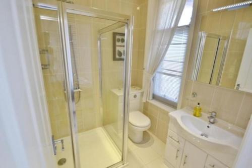 a bathroom with a shower and a toilet and a sink at Springhill House in Swanage