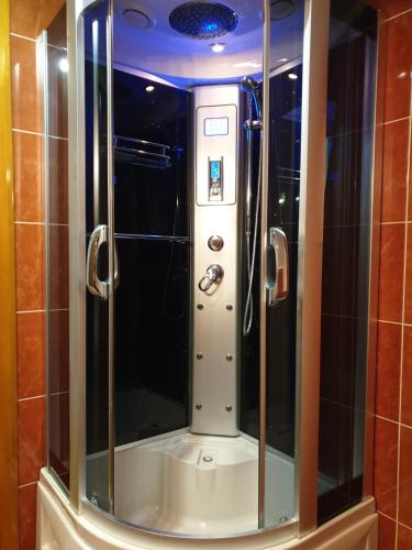 a shower with a glass door in a bathroom at Apartmani Ćurković in Kupres