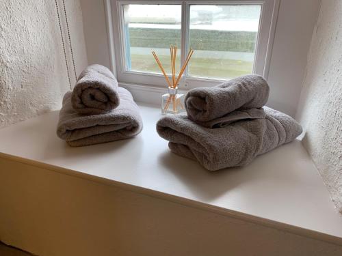 a couple of towels sitting on a window sill at Blas Mwy Black Lion B and B in Holyhead