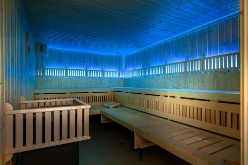 a row of benches in a room with blue lights at Vincci EverEden in Anavissos