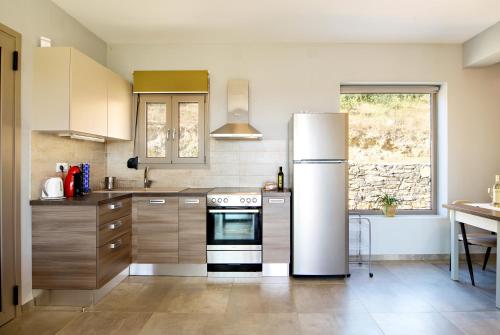 a kitchen with a refrigerator and a table in it at Villa Aias in Plakias