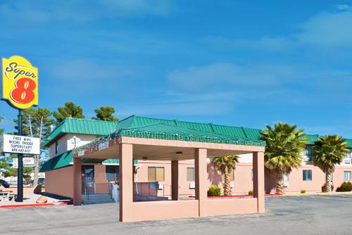 a gas station with a building with a green roof at Super 8 by Wyndham Alamogordo - White Sands in Alamogordo