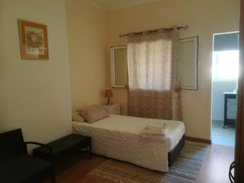 a small bedroom with a bed and a window at Cc39- Q5 in Funchal