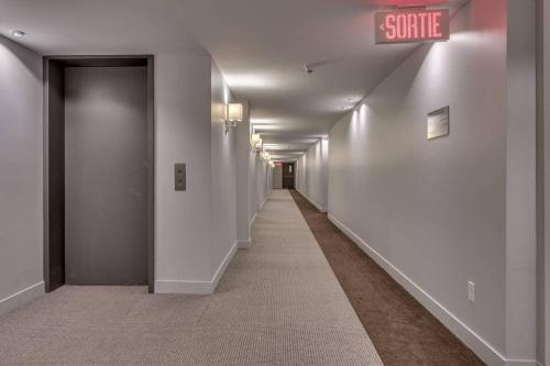 a long hallway with a sign that reads shuttle at INITIAL - L'OURS - Mont-Sainte-Anne in Beaupré