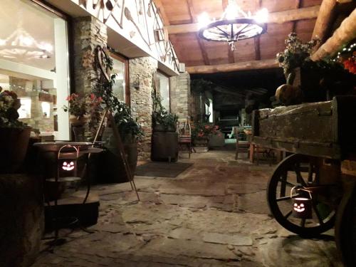 a room with a stone floor and a building with a wheel at Agriturismo Il Balcone sulla Valle in Bedero Valcuvia