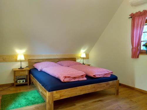 a bed in a room with two pillows on it at Kellerstöckl am Liendlberg in Eberau