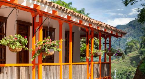 a building with potted plants and flowers on it at Finca La Manchuria in Salgar