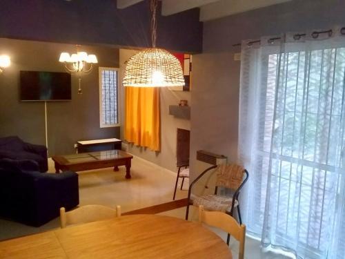 a living room with a table and a dining room at Shangri la in Mendoza