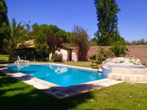 a swimming pool in the yard of a house at Shangri la in Mendoza