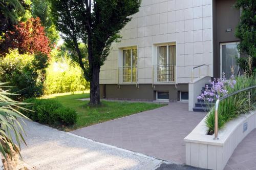 a building with purple flowers in front of it at San Giorgio, Sure Hotel Collection by Best Western in Forlì