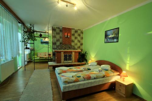 a bedroom with two beds and a fireplace at Privat Horec in Malý Slavkov