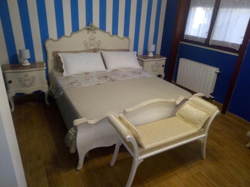 a bedroom with a bed and a chair in it at Villa sullo stretto in SantʼAgata