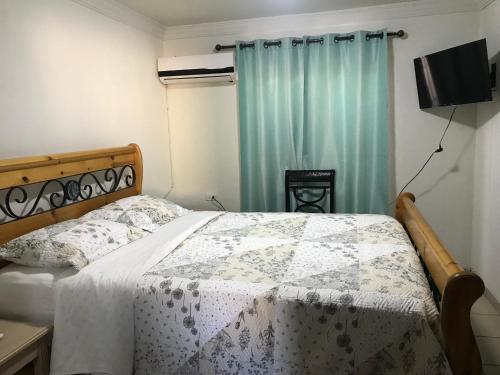 a bedroom with a bed with a quilt on it at Apartamento Siesta Del Sol II in Puerto Peñasco