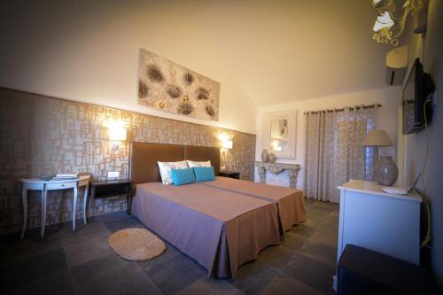 a bedroom with a large bed and a table at Quinta do Louro in Palmela