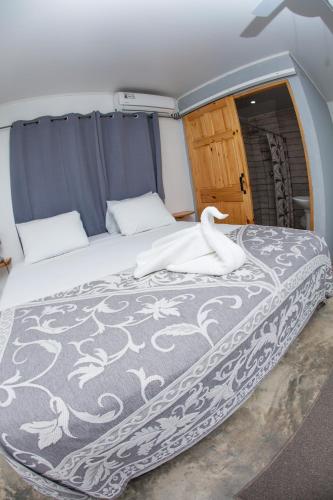 a bedroom with a bed with a swan on it at Show Pony Beach Resort and Suites in Las Lajas