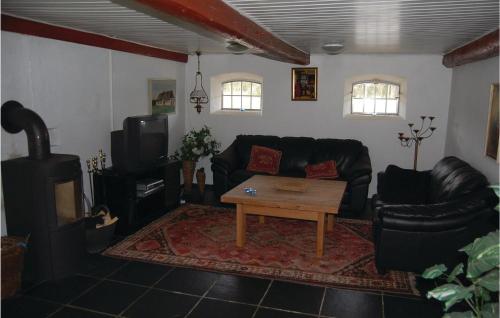 a living room with a couch and a coffee table at Three-Bedroom Holiday Home In Blavand in Blåvand