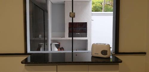 a kitchen counter with a window and a toaster on it at SOCRA Trinidad in Asuncion