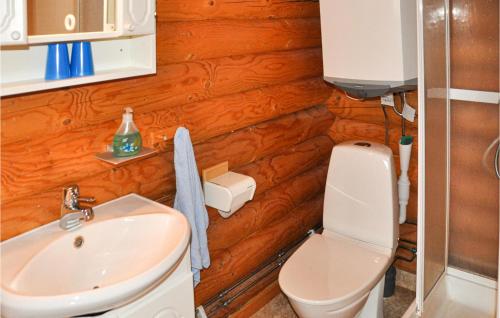 a bathroom with a white sink and a toilet at 2 Bedroom Beautiful Home In Sunne in Sunne