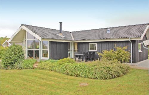 a gray house with a lawn in front of it at Holiday Home Grønkær Høj Vej Haderslev X in Haderslev