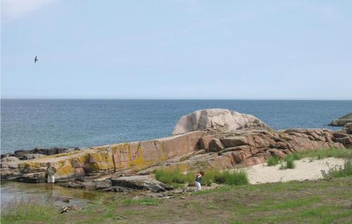 a group of people standing on the beach near the ocean at Strandpromenaden in Sandvig