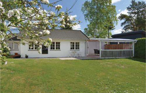 a white house with a lawn in front of it at Holiday Home Silkeborg 9 Denmark in Silkeborg