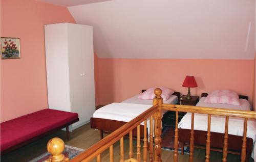 a small room with two beds and a staircase at Nice Home In Rewal With 1 Bedrooms in Rewal