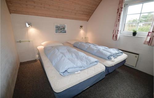 Bøtø ByにあるNice Home In Vggerlse With Saunaのベッドルーム1室(ベッド2台、窓付)