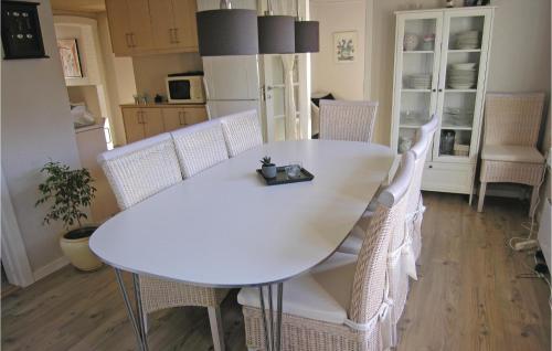 a white dining table and chairs in a kitchen at Holiday Home Solbakken Rudkøbing Vi in Spodsbjerg