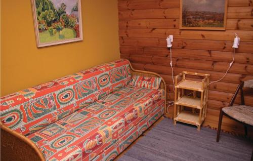 ein Wohnzimmer mit einem Sofa und einer Holzwand in der Unterkunft Kanalhytten in Rømø Kirkeby