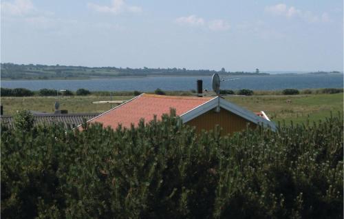 a house with a barn and the water in the background at Holiday Home Klintebakkevej Millinge X in Millinge