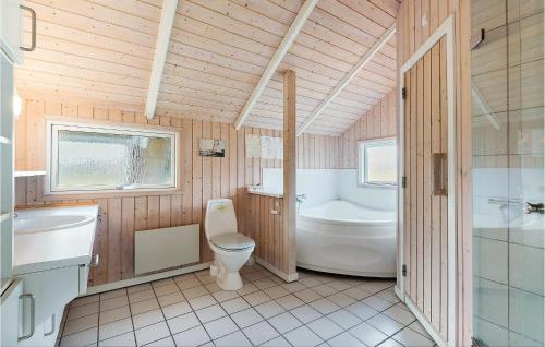 a bathroom with a toilet and a tub and a sink at Three-Bedroom Holiday Home In Sydals in Skovbyballe