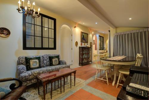 a living room with a couch and a table at Chateau de Prim Khao Yai in Ban Sap Phlu