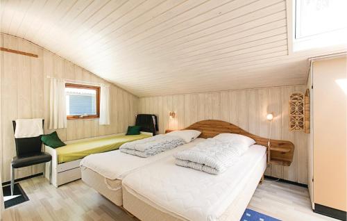 SpidsegårdにあるAwesome Home In Nex With 3 Bedrooms, Sauna And Wifiのベッドルーム1室(ベッド2台、椅子付)