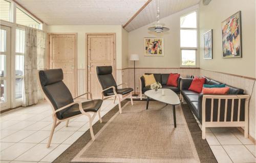 a living room with a couch and chairs at Holiday Home Strandparken Dnmk Ii in Otterup