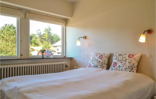 a bedroom with a bed with two pillows and a window at Beautiful Home In Nrre Nebel With Wifi in Nymindegab