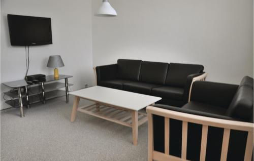a living room with a couch and a table at One-Bedroom Apartment In Sydals in Tandslet