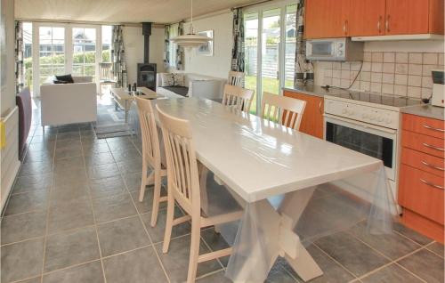 a kitchen with a large white table and chairs at 2 Bedroom Lovely Home In Hejls in Hejls