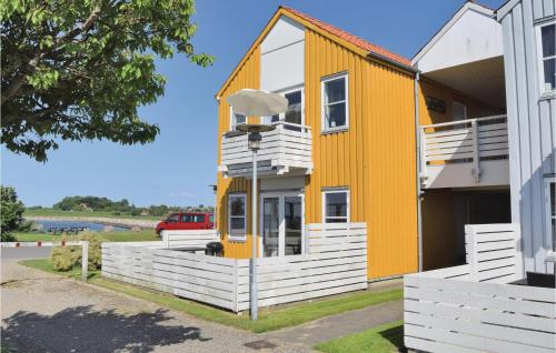a yellow house with white balconies on a building at Apartment Skudehavnen Rudkøbing Vi in Rudkøbing